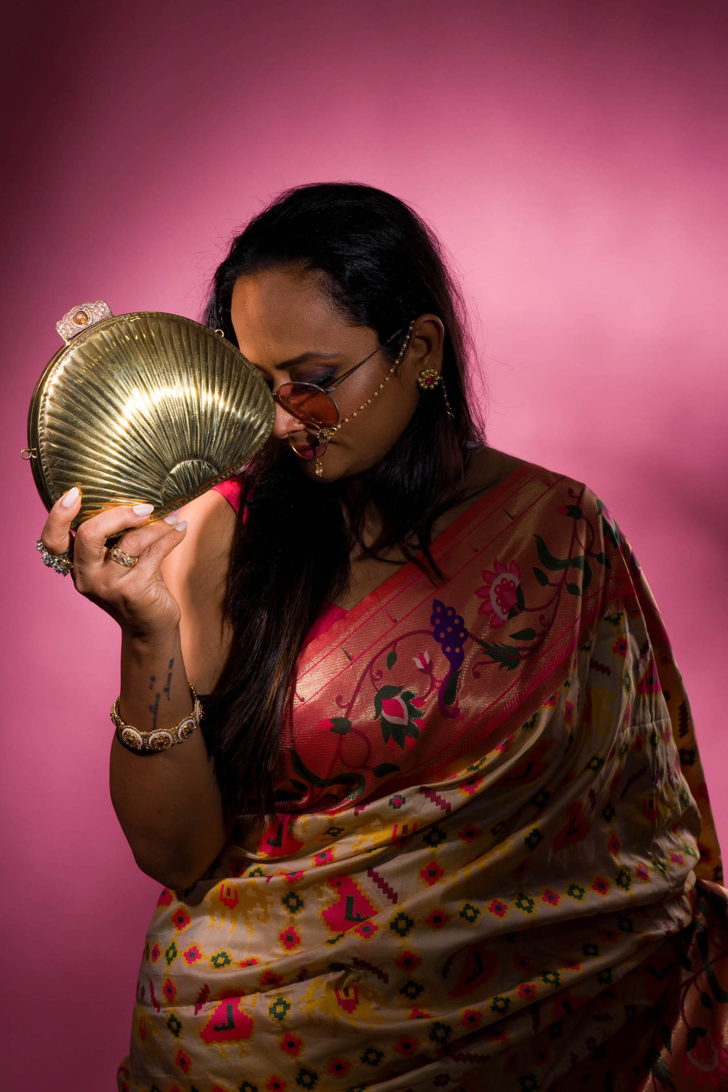 Ethnic brass bag in shell shape