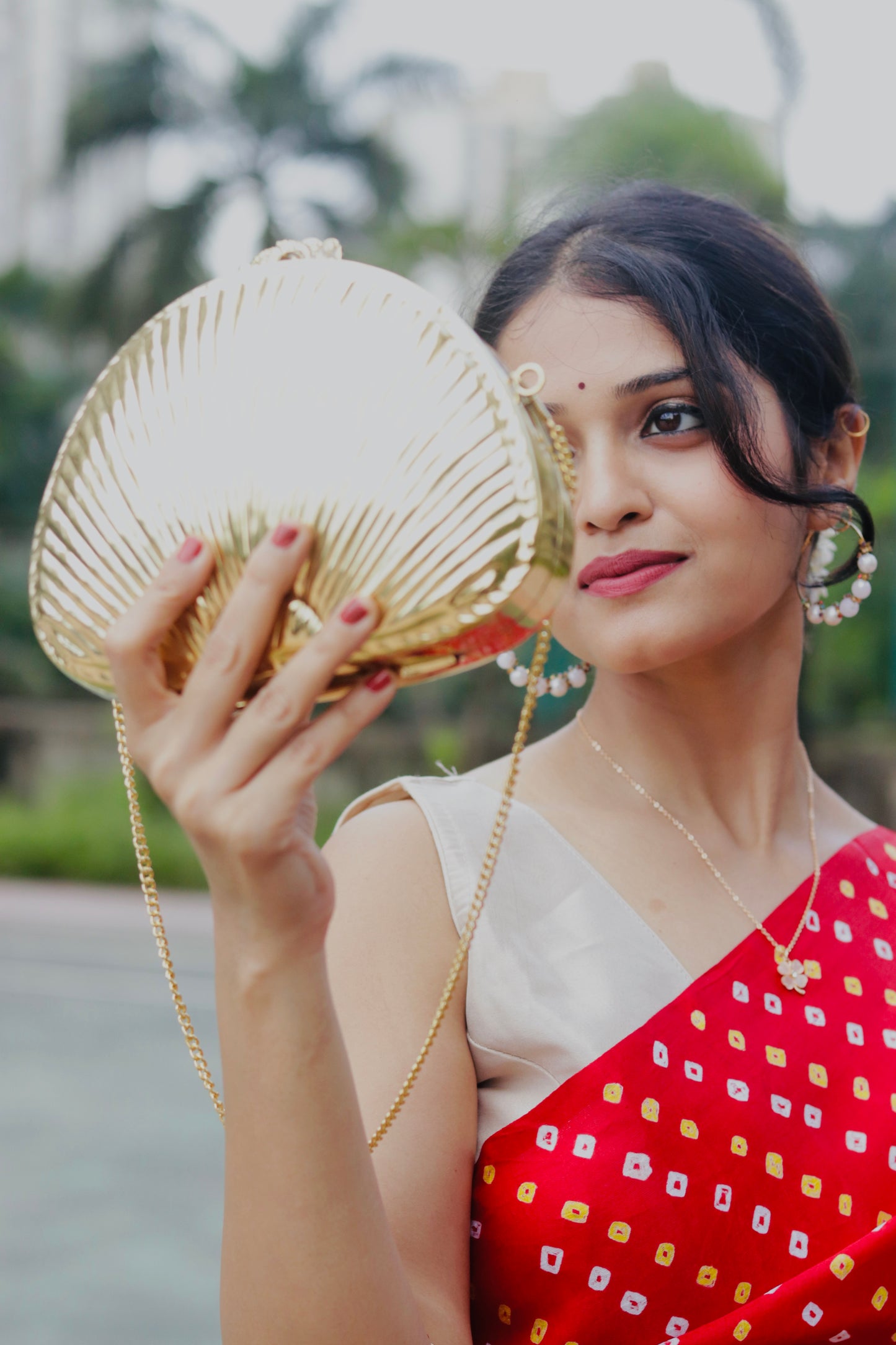 Ethnic brass bag in shell shape