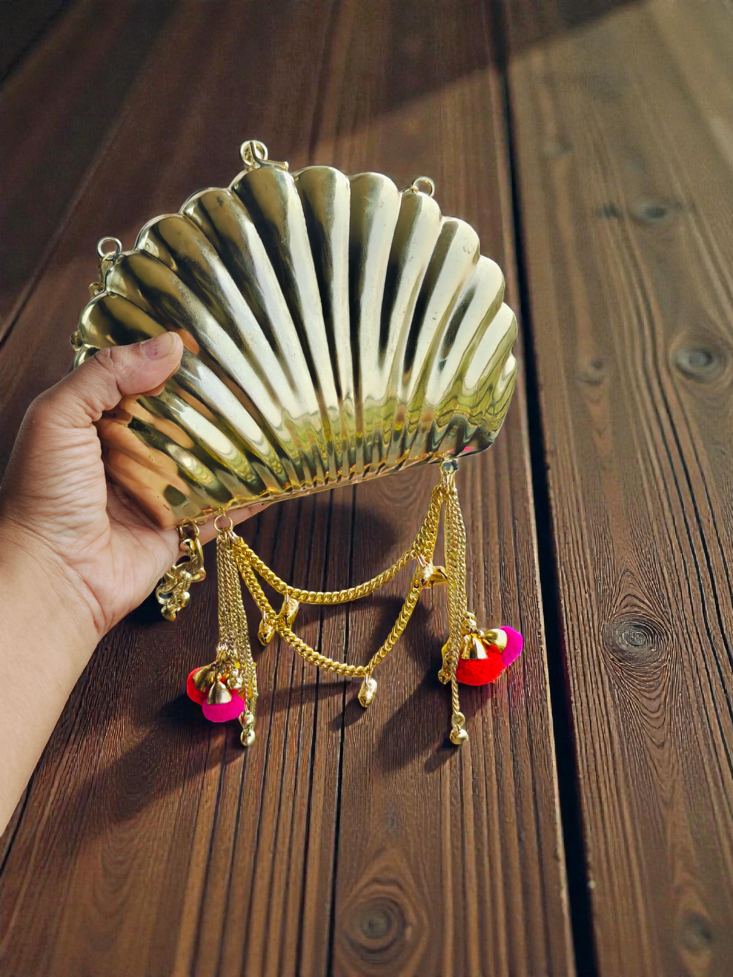 The Shell Heritage Brass Ghungroo bag in gold tone