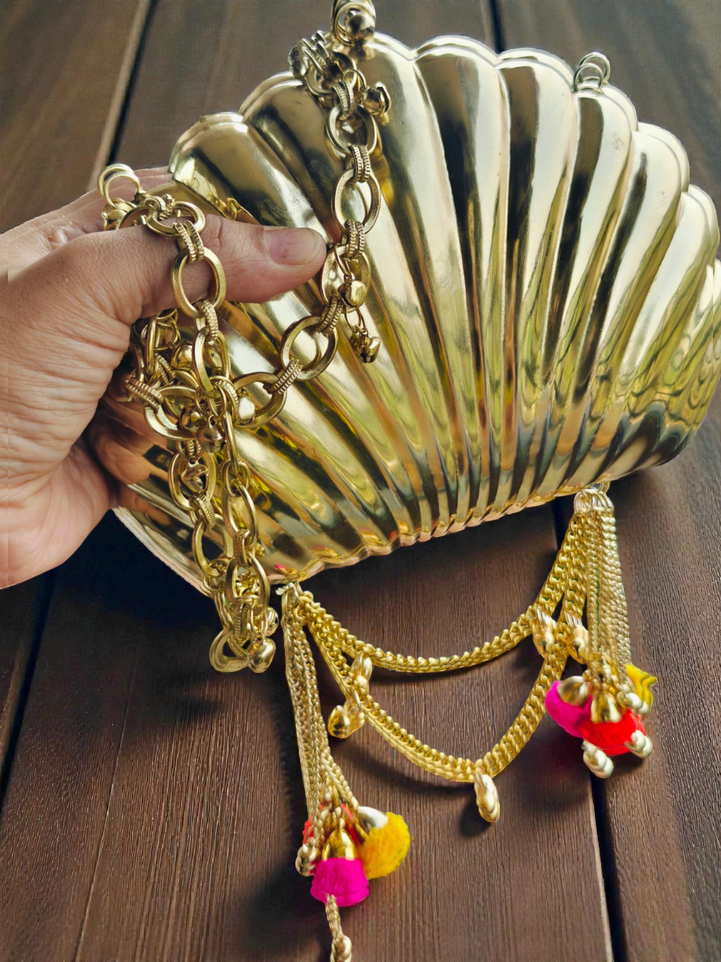 The Shell Heritage Brass Ghungroo bag in gold tone