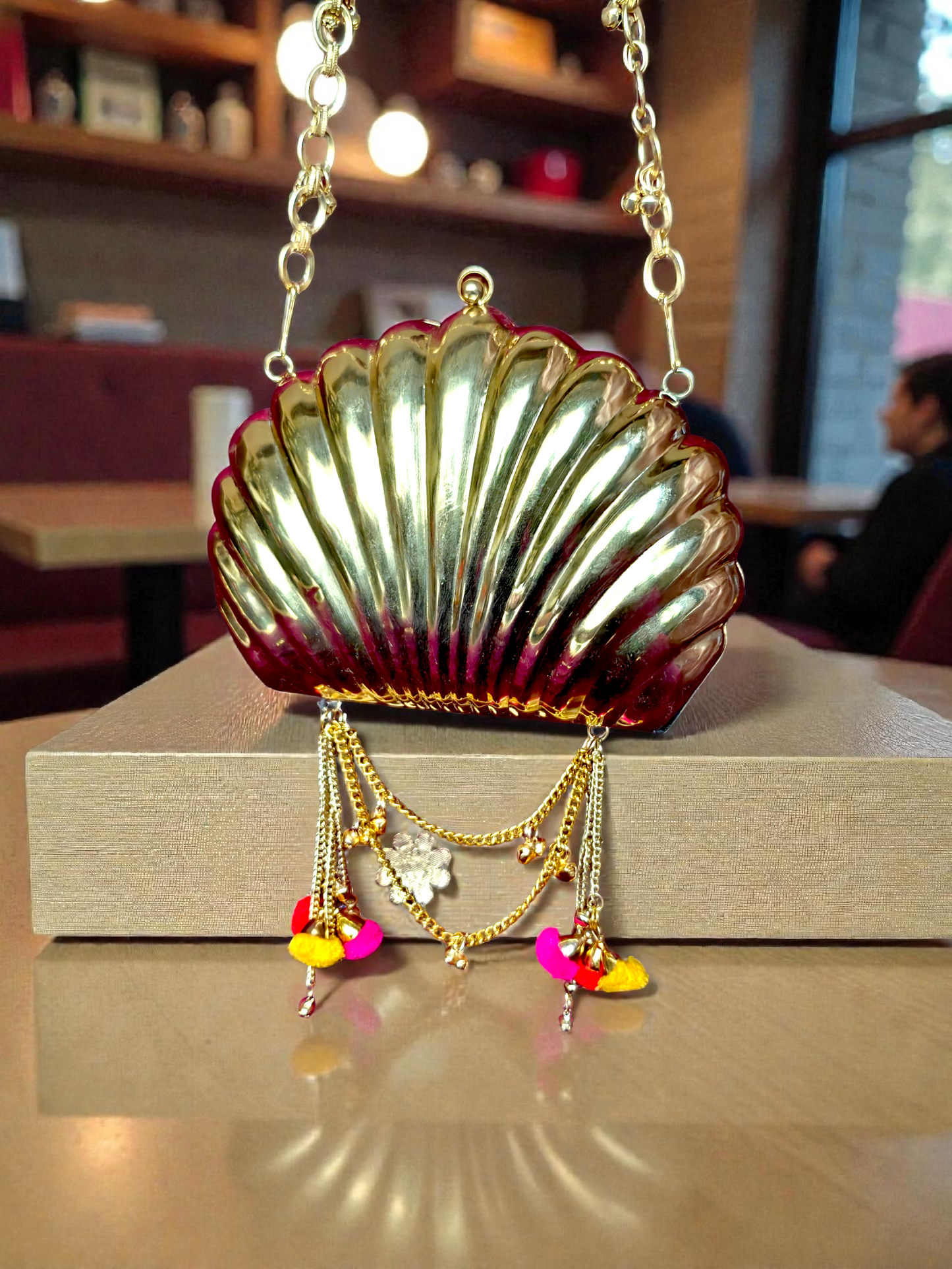 The Shell Heritage Brass Ghungroo bag in gold tone