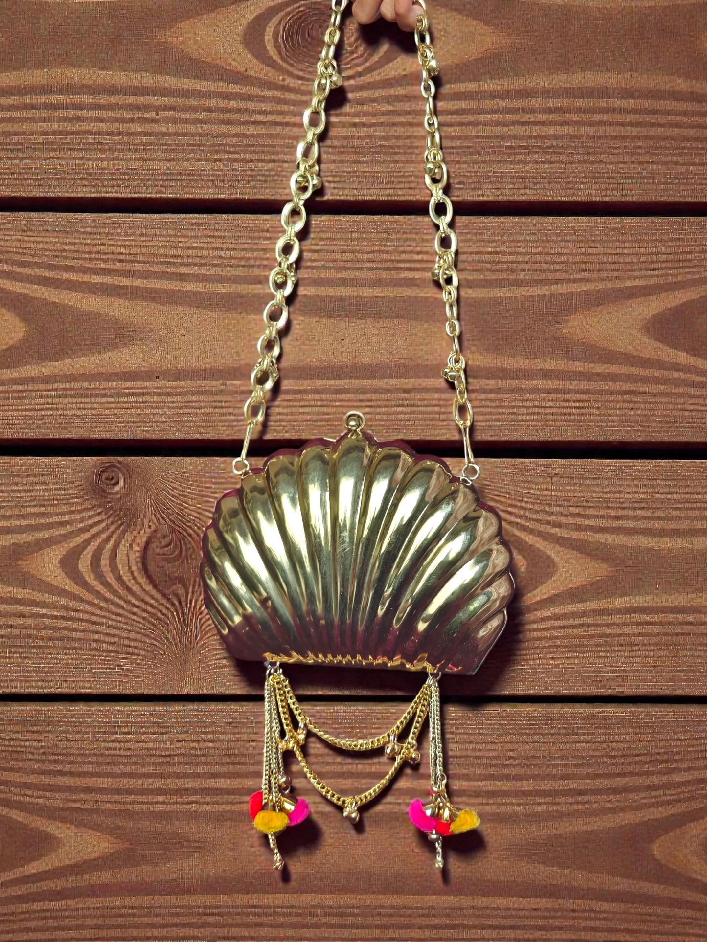 The Shell Heritage Brass Ghungroo bag in gold tone