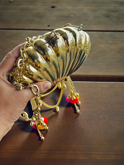 The Shell Heritage Brass Ghungroo bag in gold tone